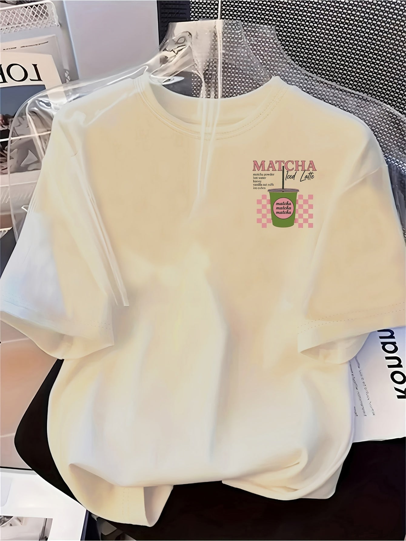 [Trendy, Matcha Lover Tee] Trendy Casual Tee - Women's Matcha Lover Graphic Tee | Light Pink with Green & White Checkered Design, "Matcha Powder Hot Water Vanilla Oat Milk Ice Cubes" Print, Casual Short Sleeve Crew Neck, Perf